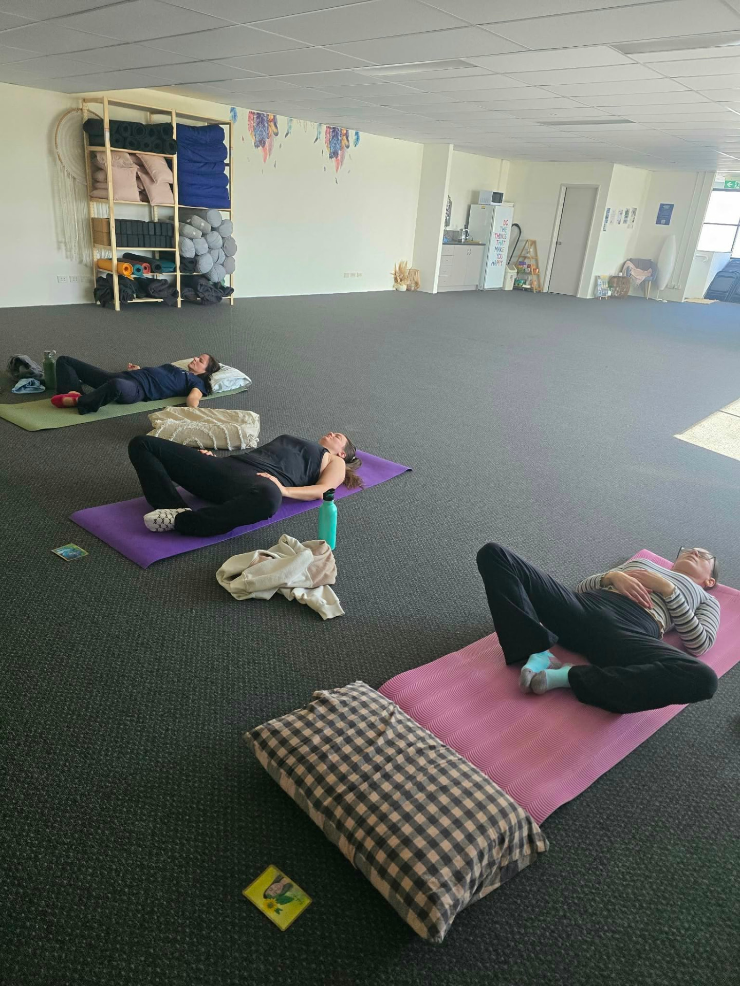 Women resting on their mats during the mindful cooldown