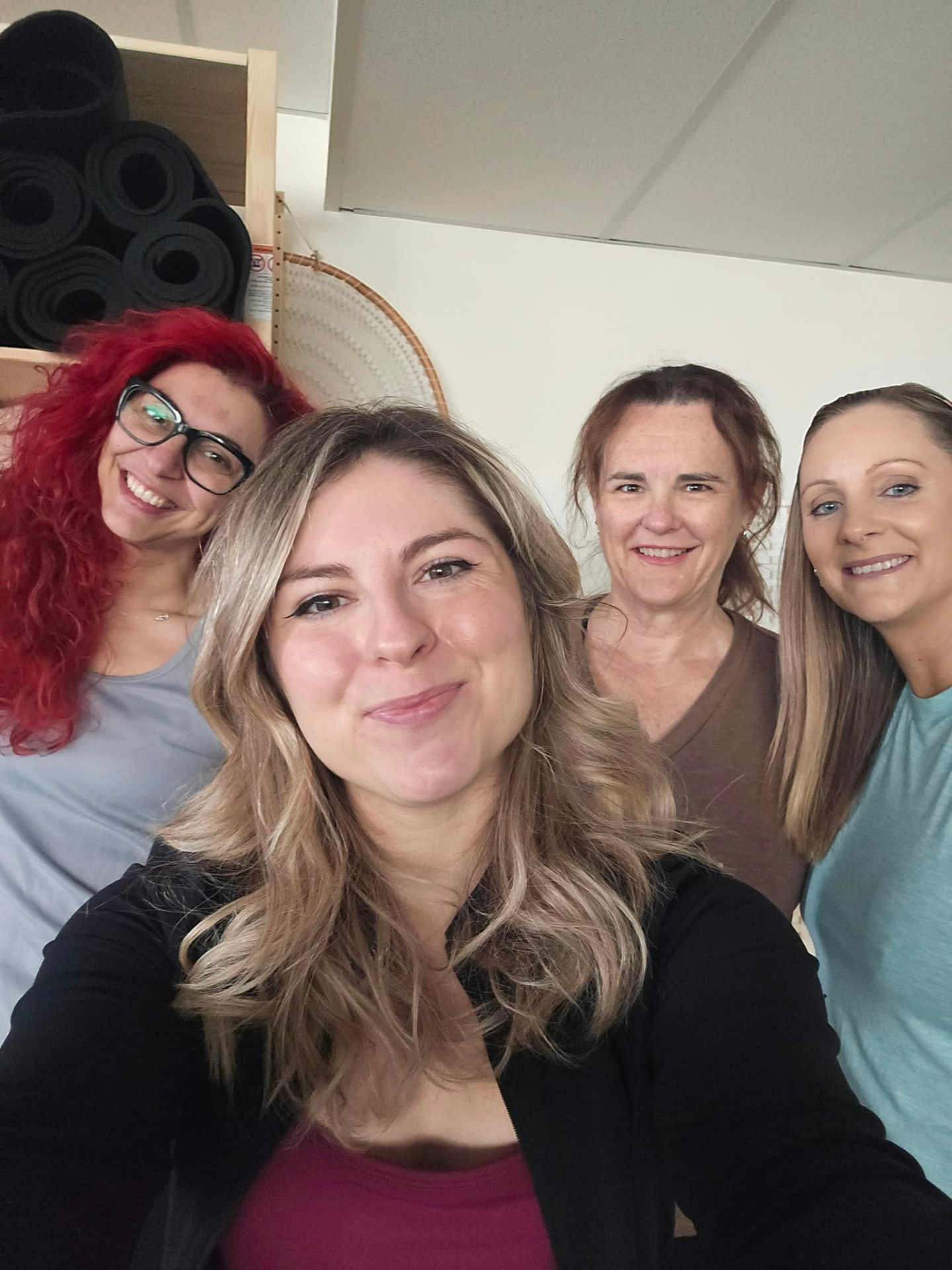 Daisy and three smiling clients taking a selfie together after the session